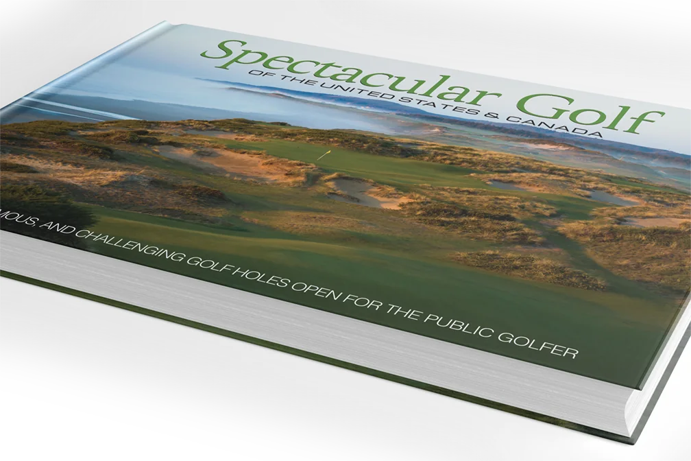 The Spectacular Golf hardcover resting on a desk — the golf gift that always fits